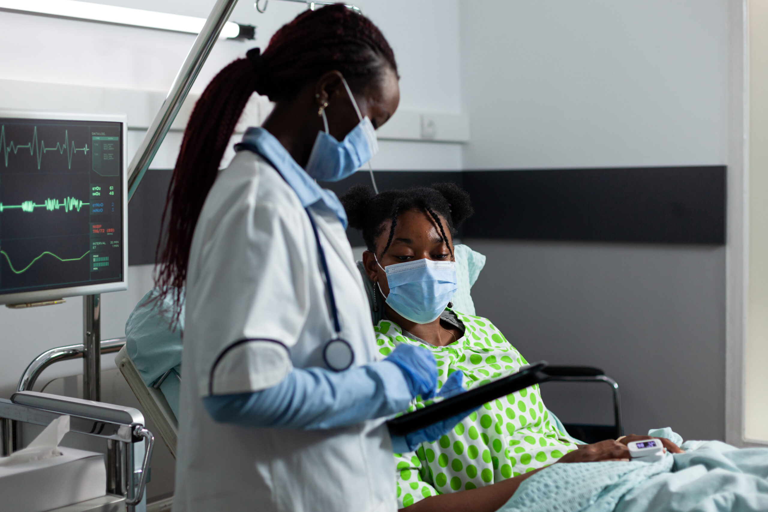 medic of african ethnicity helping sick patient at clinic